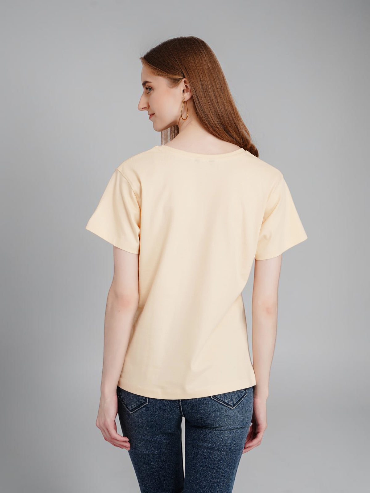 enaay.com women's beige crew-neck cotton t-shirt worn by a model, back view showing plain design
