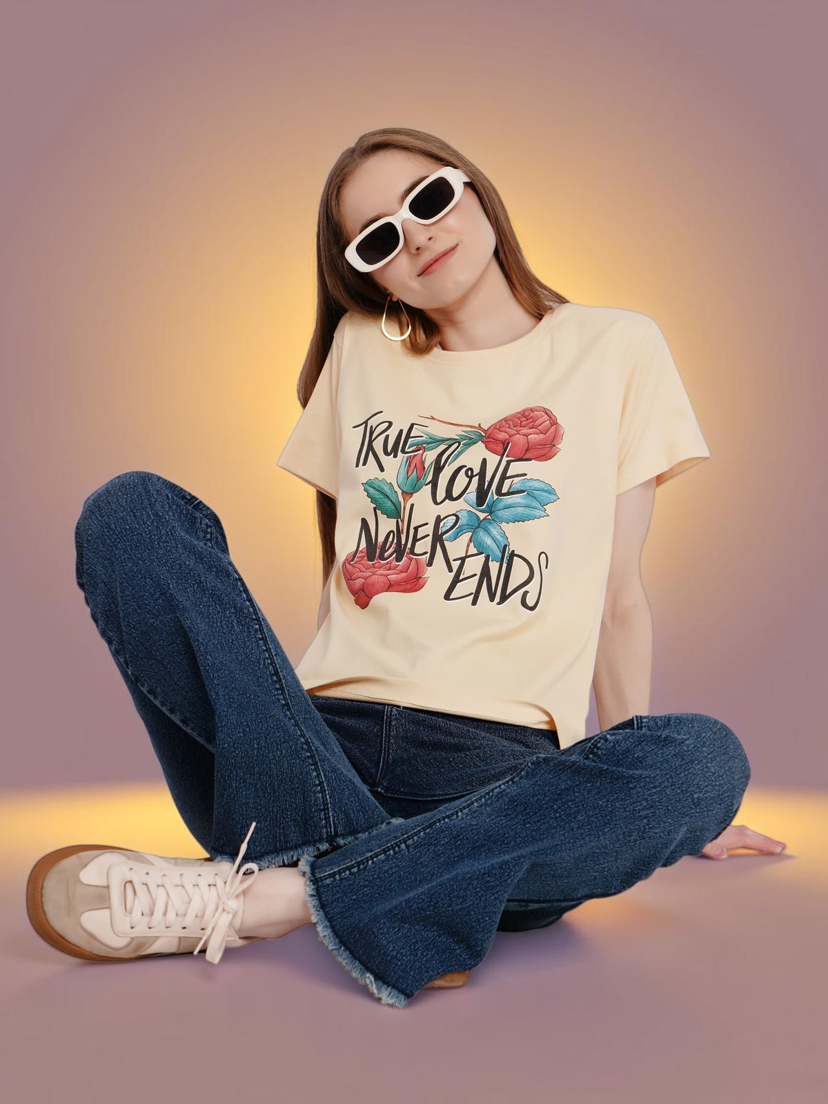Woman wearing an enaay.com beige cotton crew-neck t-shirt with a True Love Never Ends floral graphic and sunglasses