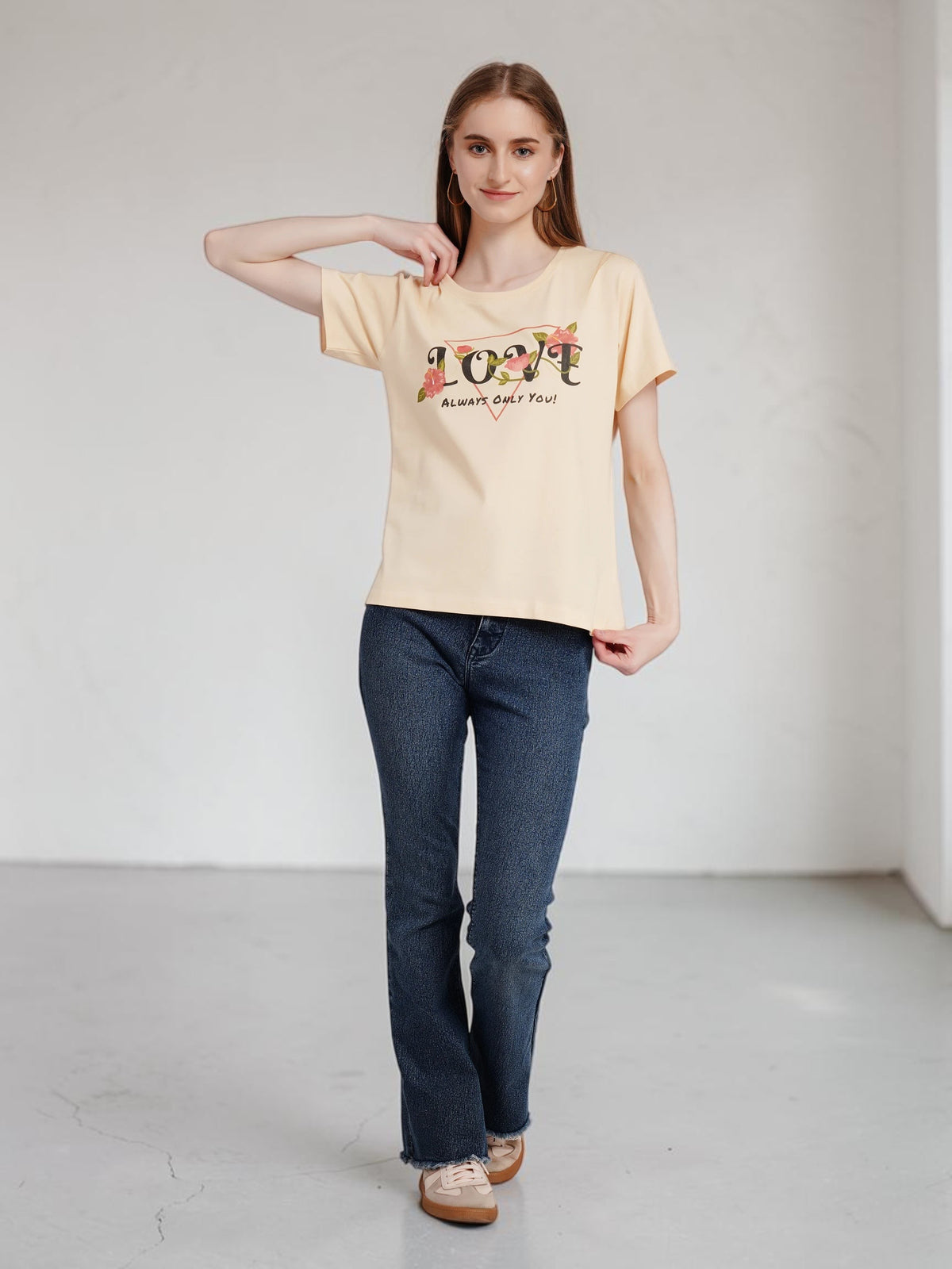 Model wearing an enaay.com beige crew-neck cotton t-shirt with Love Always Only You floral graphic print and jeans.