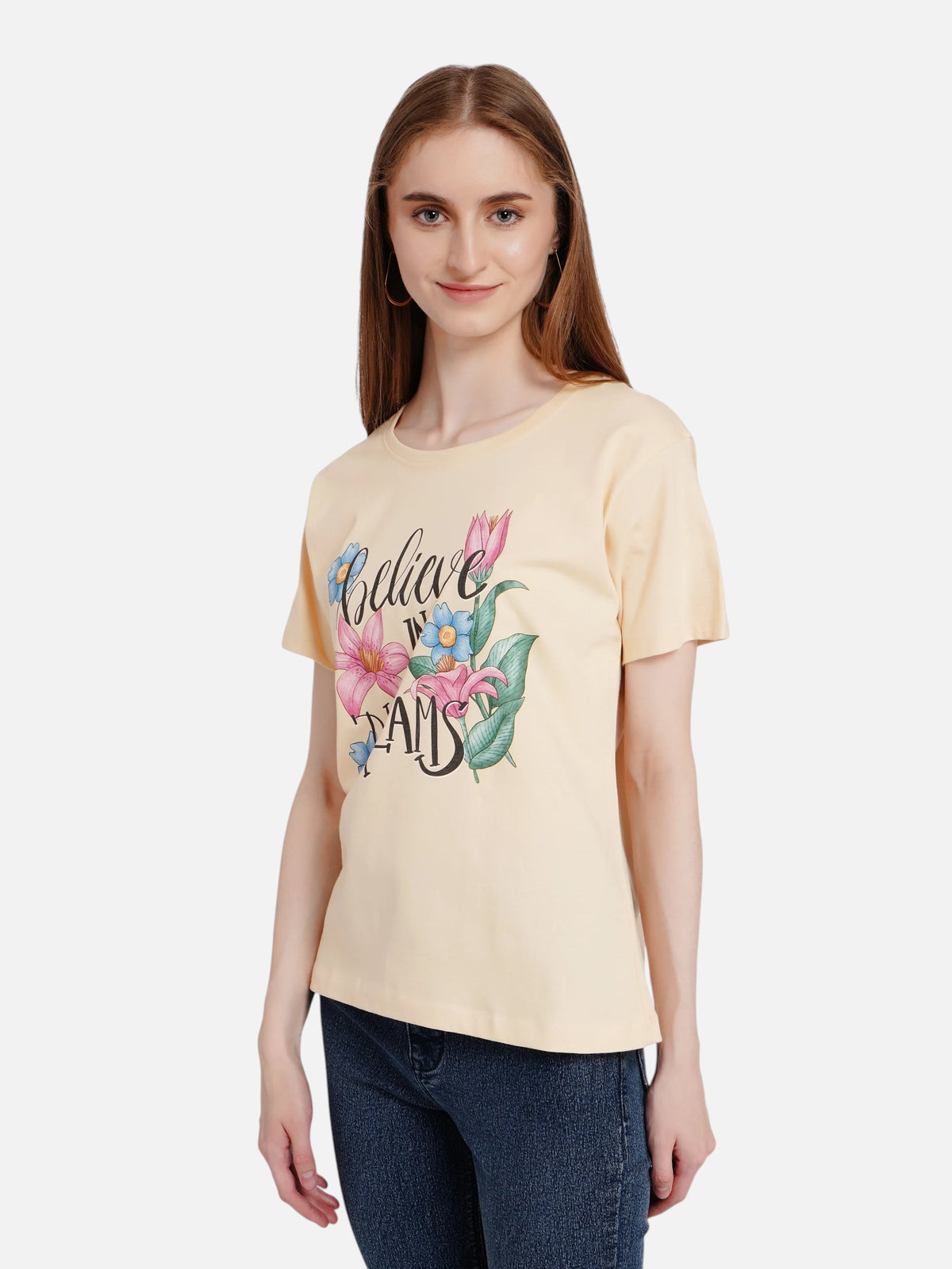 Model wearing an enaay.com light beige cotton t-shirt with a Believe In Dreams floral graphic print
