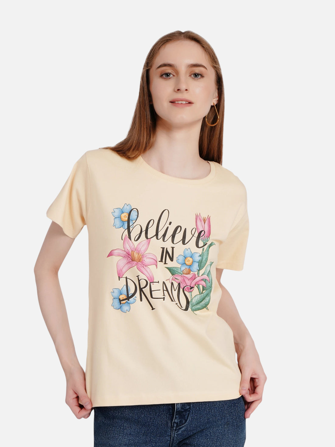 Model wearing an enaay.com light beige cotton t-shirt with a floral Believe In Dreams graphic print