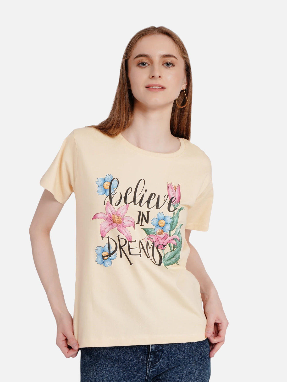 Model wearing an enaay.com light beige cotton t-shirt with a floral Believe In Dreams graphic print
