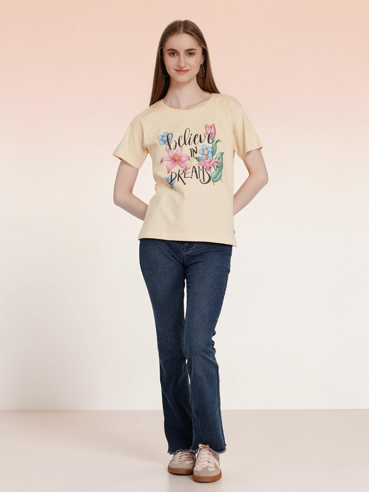 Model wearing an enaay.com light beige cotton t-shirt with a Believe In Dreams floral graphic and round neck