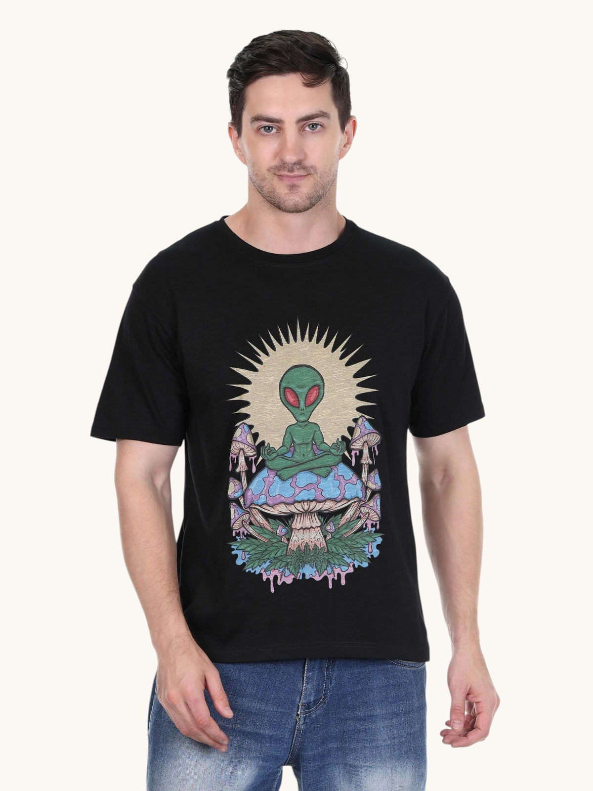Model wearing an enaay.com black cotton t-shirt with a psychedelic meditating alien and mushroom graphic print.