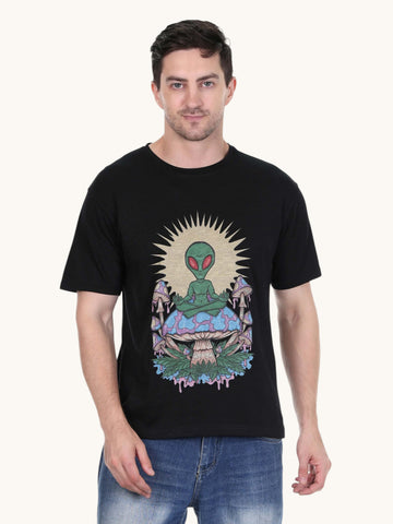 Model wearing an enaay.com black cotton t-shirt with a psychedelic meditating alien and mushroom graphic print.