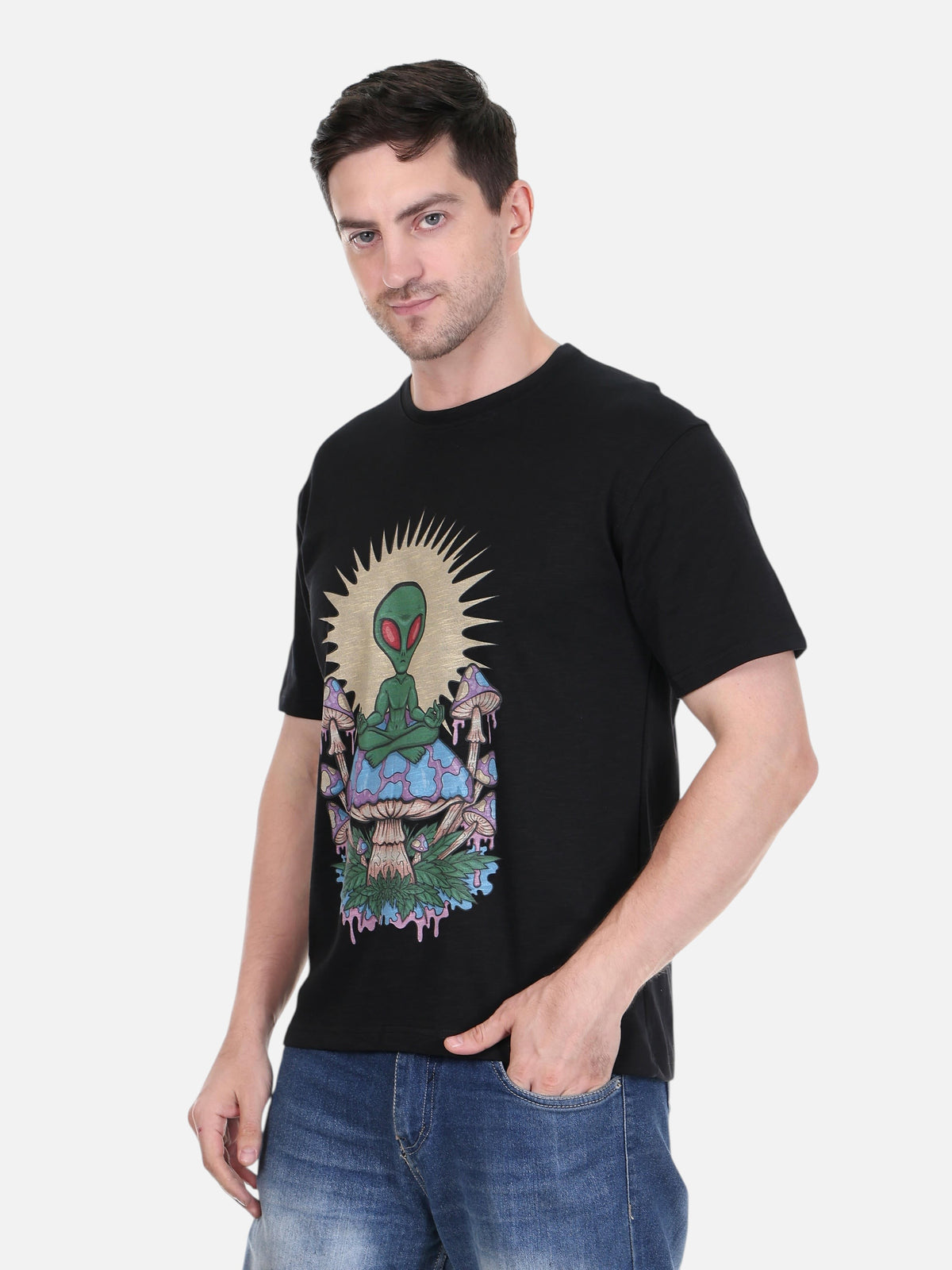 A man wearing an enaay.com black cotton t-shirt featuring a psychedelic meditating alien on a mushroom graphic.
