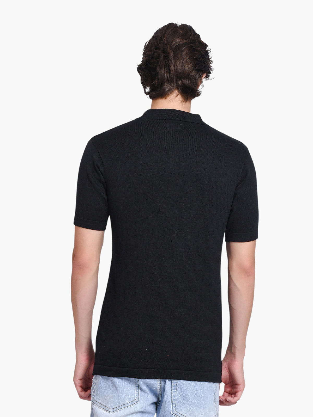 Back view of a man wearing an enaay.com black pure cotton knitted polo shirt with short sleeves and a classic collar.