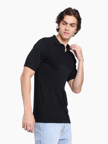Model wearing an enaay.com black pure cotton knitted polo shirt with a classic collar and short sleeves