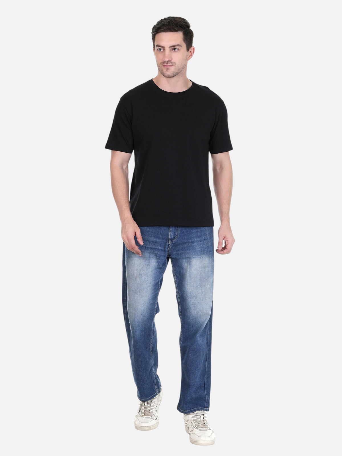 Model wearing an enaay.com black solid cotton round neck t-shirt with blue jeans and white sneakers