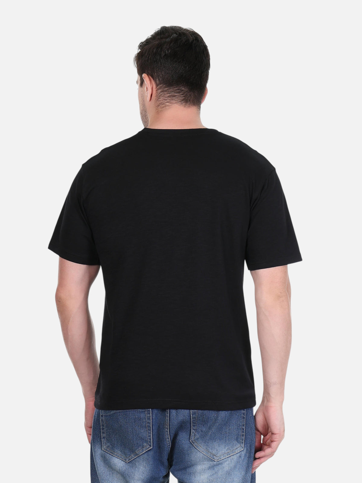 Back view of a man wearing an enaay.com black cotton round neck t-shirt with blue denim jeans