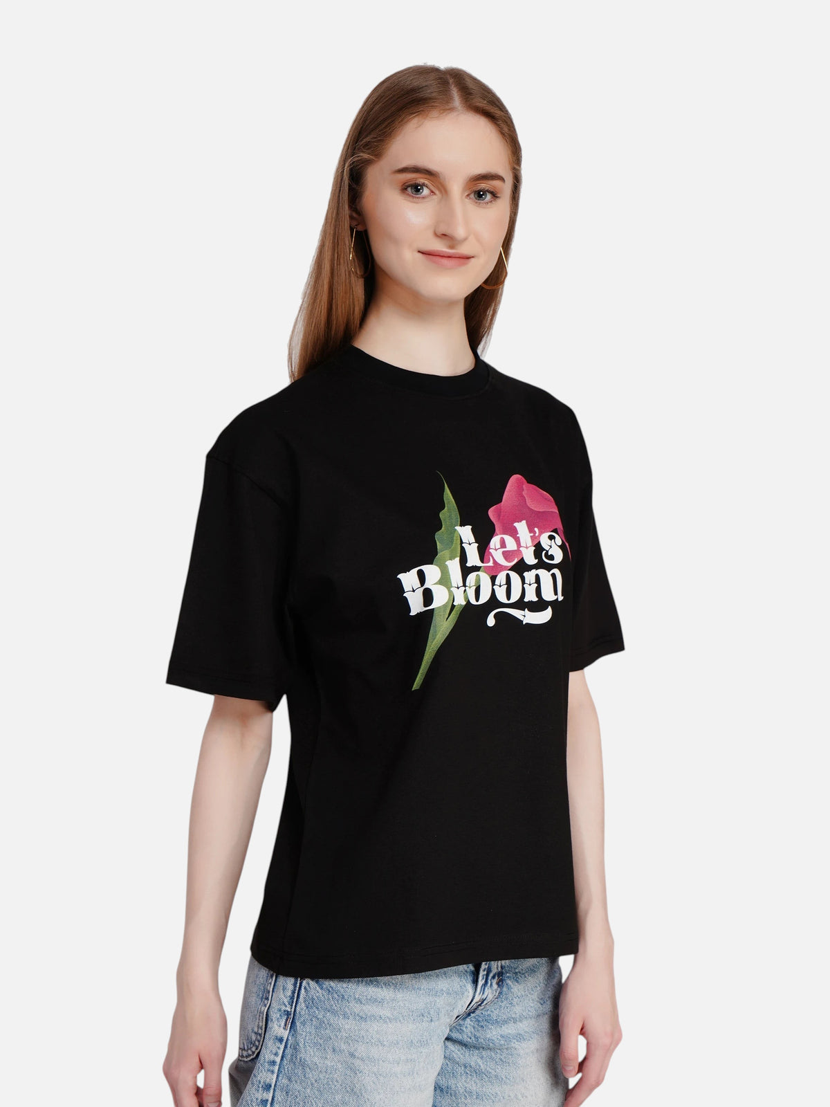 enaay.com black oversized cotton t-shirt featuring a Let's Bloom floral graphic print worn by a woman