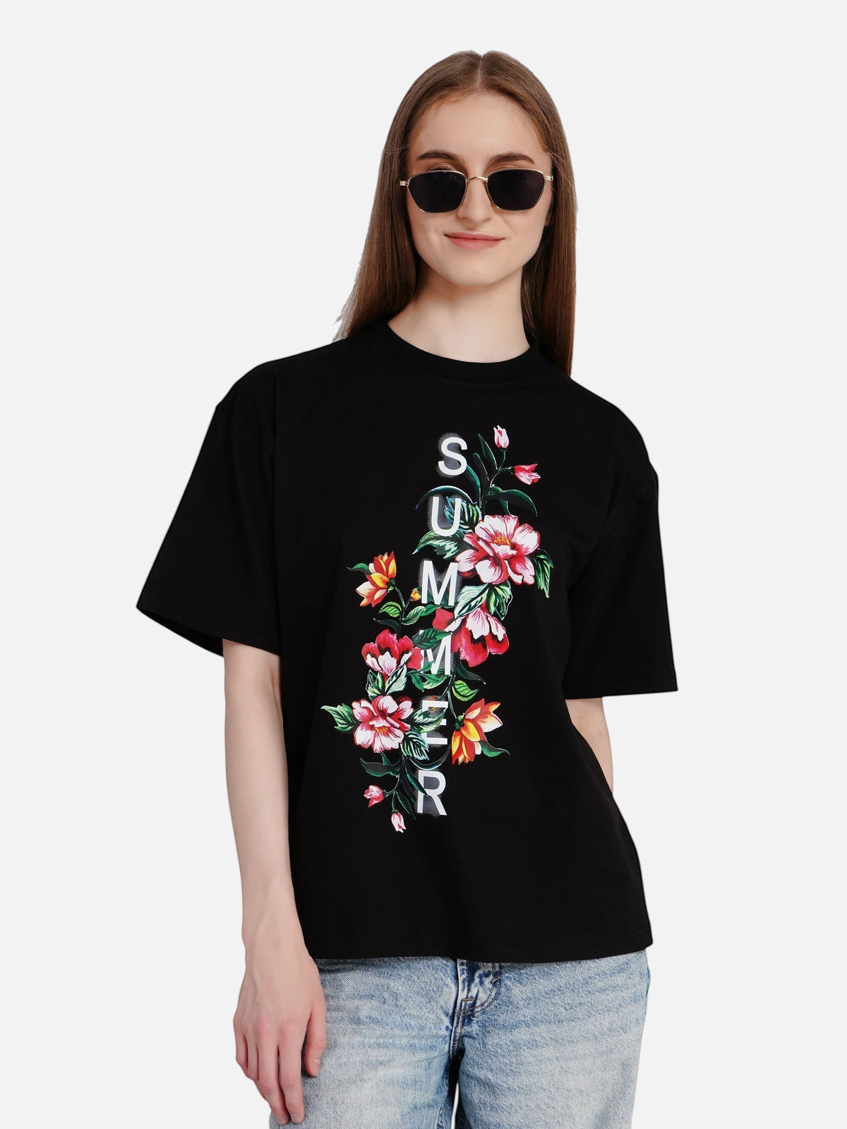 Woman wearing an enaay.com black oversized cotton t-shirt with a floral summer print and drop-shoulder fit.