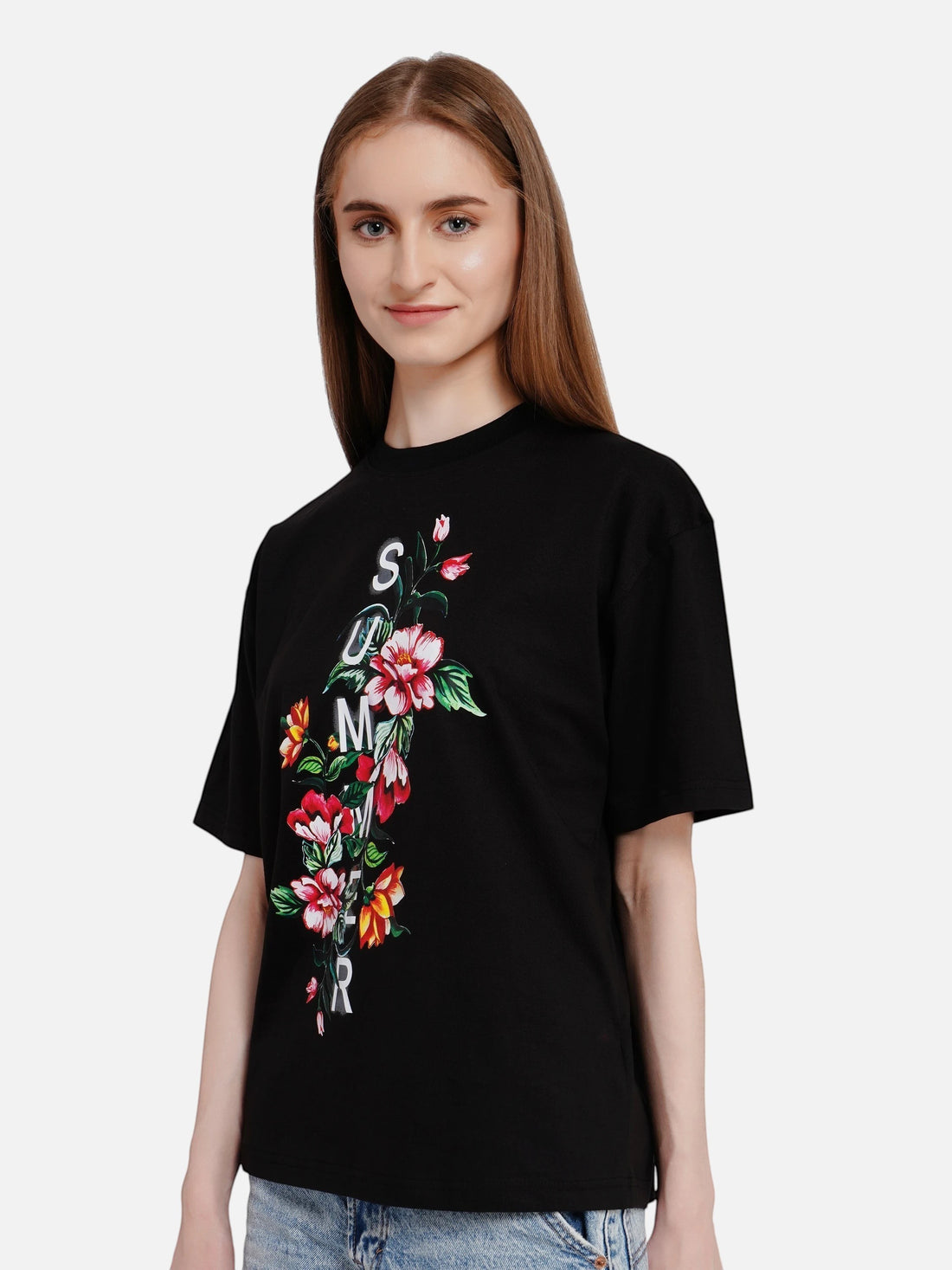 Model wearing an enaay.com black oversized cotton t-shirt with a floral print and vertical summer text graphic