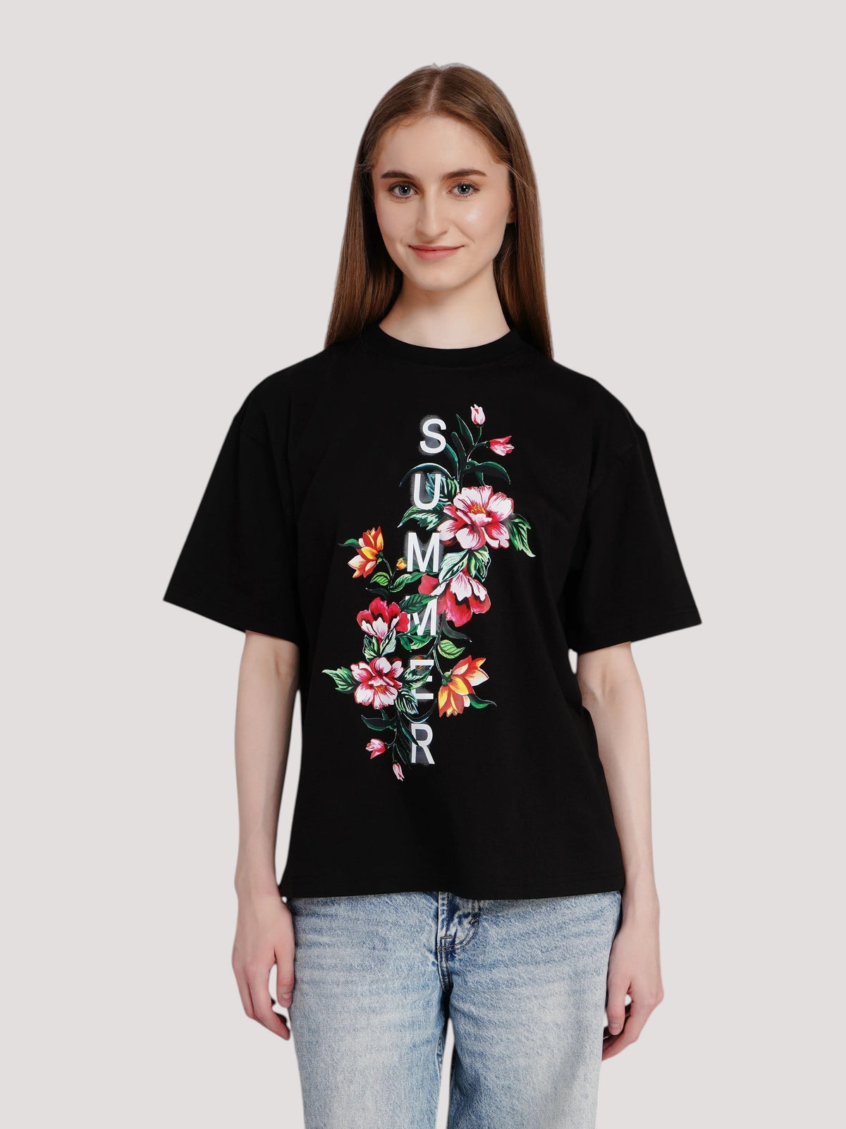 Model wearing an enaay.com black oversized cotton t-shirt with a floral print and vertical summer text graphic