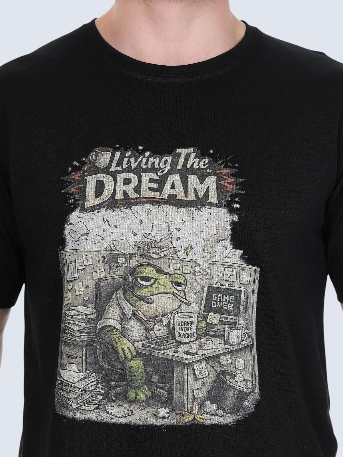 enaay.com black cotton t-shirt featuring a humorous graphic of a tired frog at an office desk with Living The Dream