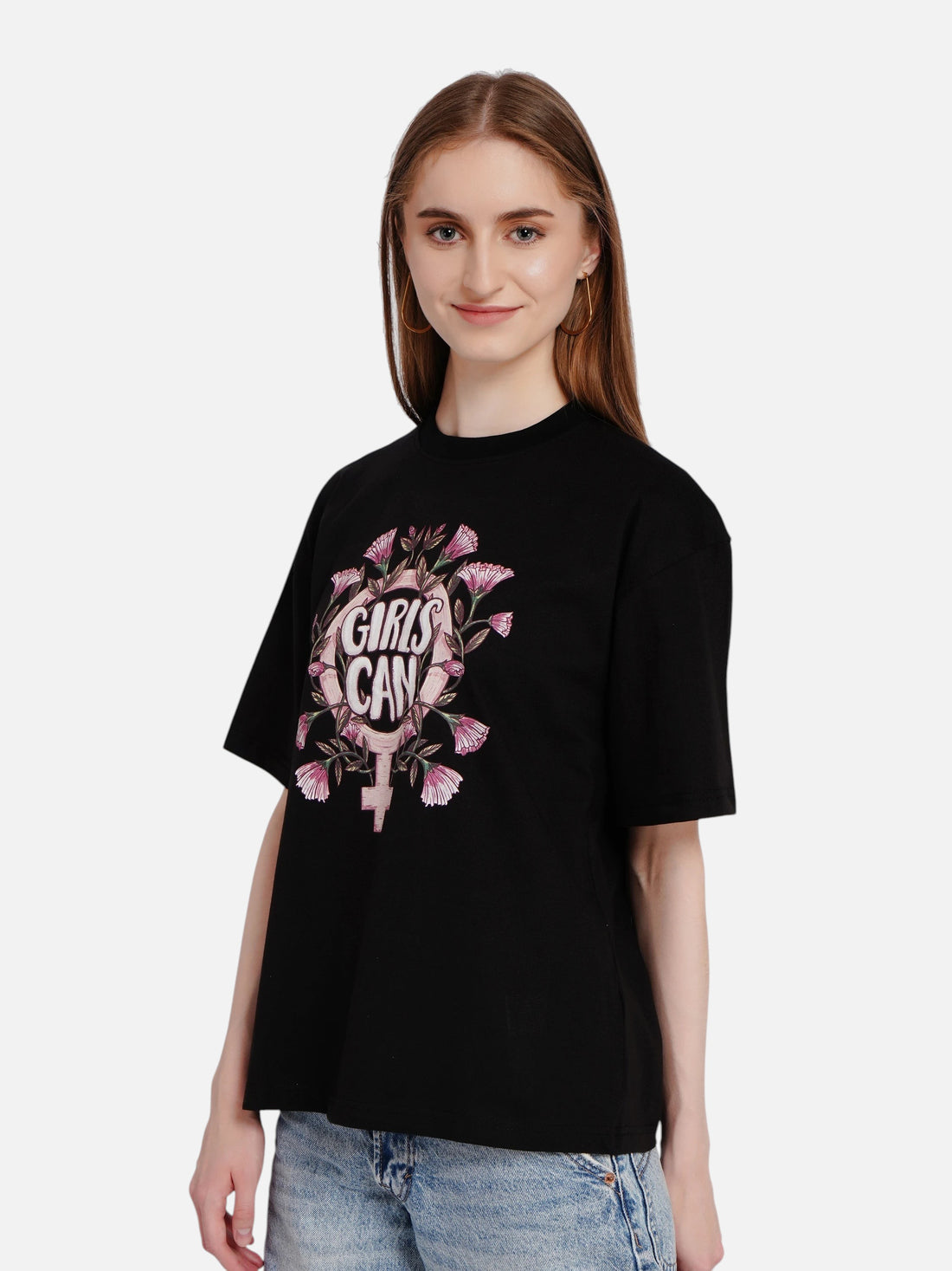 Model wearing an enaay.com black oversized cotton t-shirt with a floral Girls Can graphic print and round neckline.