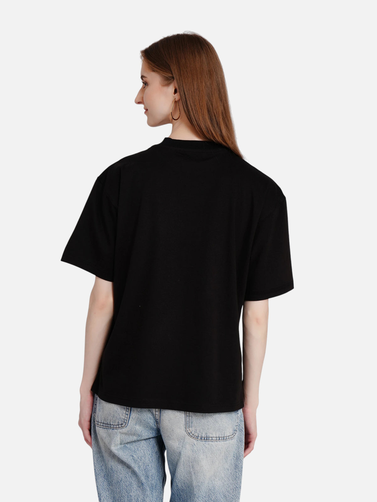 Model wearing an enaay.com black oversized cotton t-shirt with short sleeves, back view against a white background