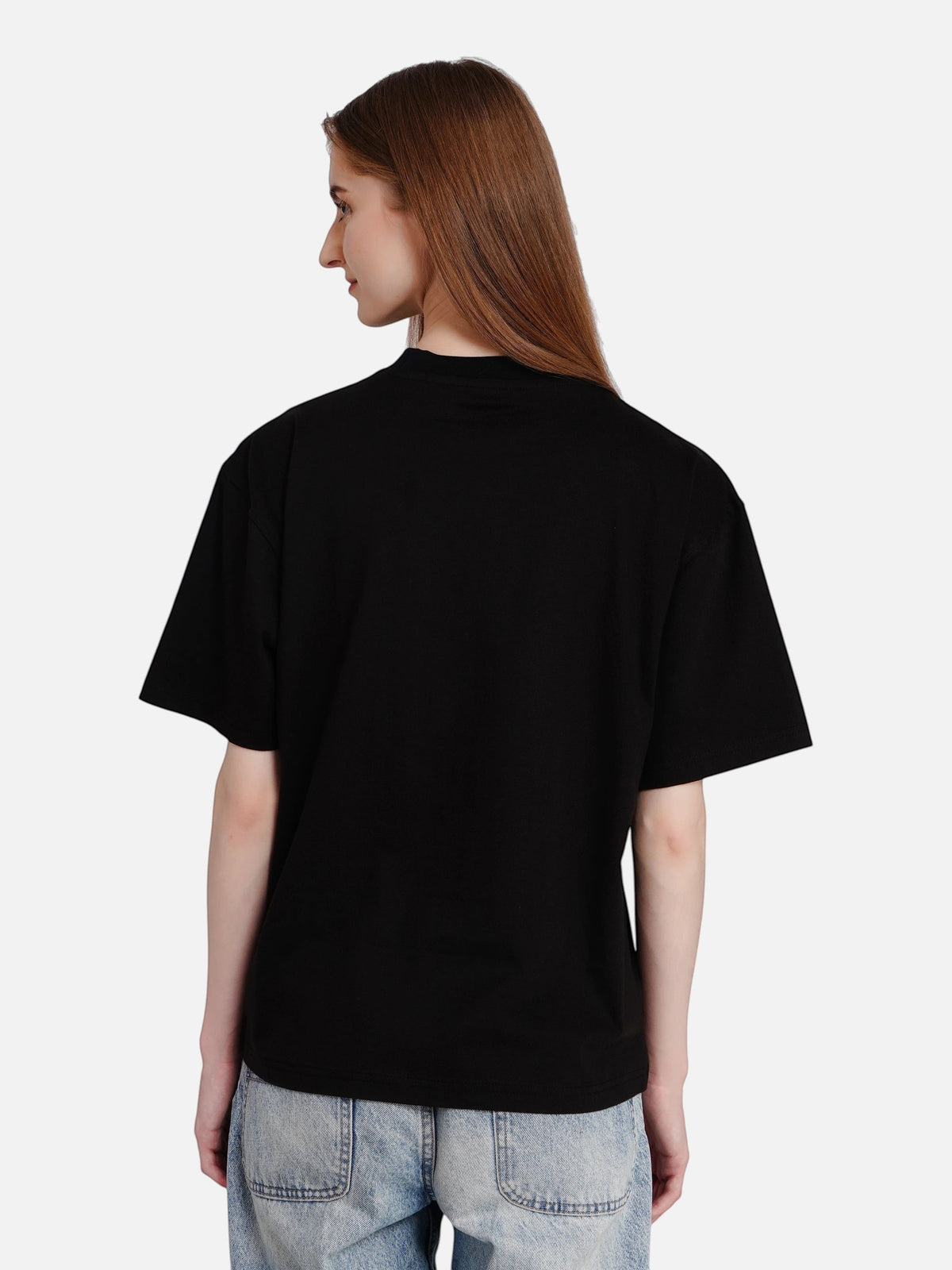 Woman wearing an enaay.com black oversized premium cotton t-shirt with a drop-shoulder fit, back view