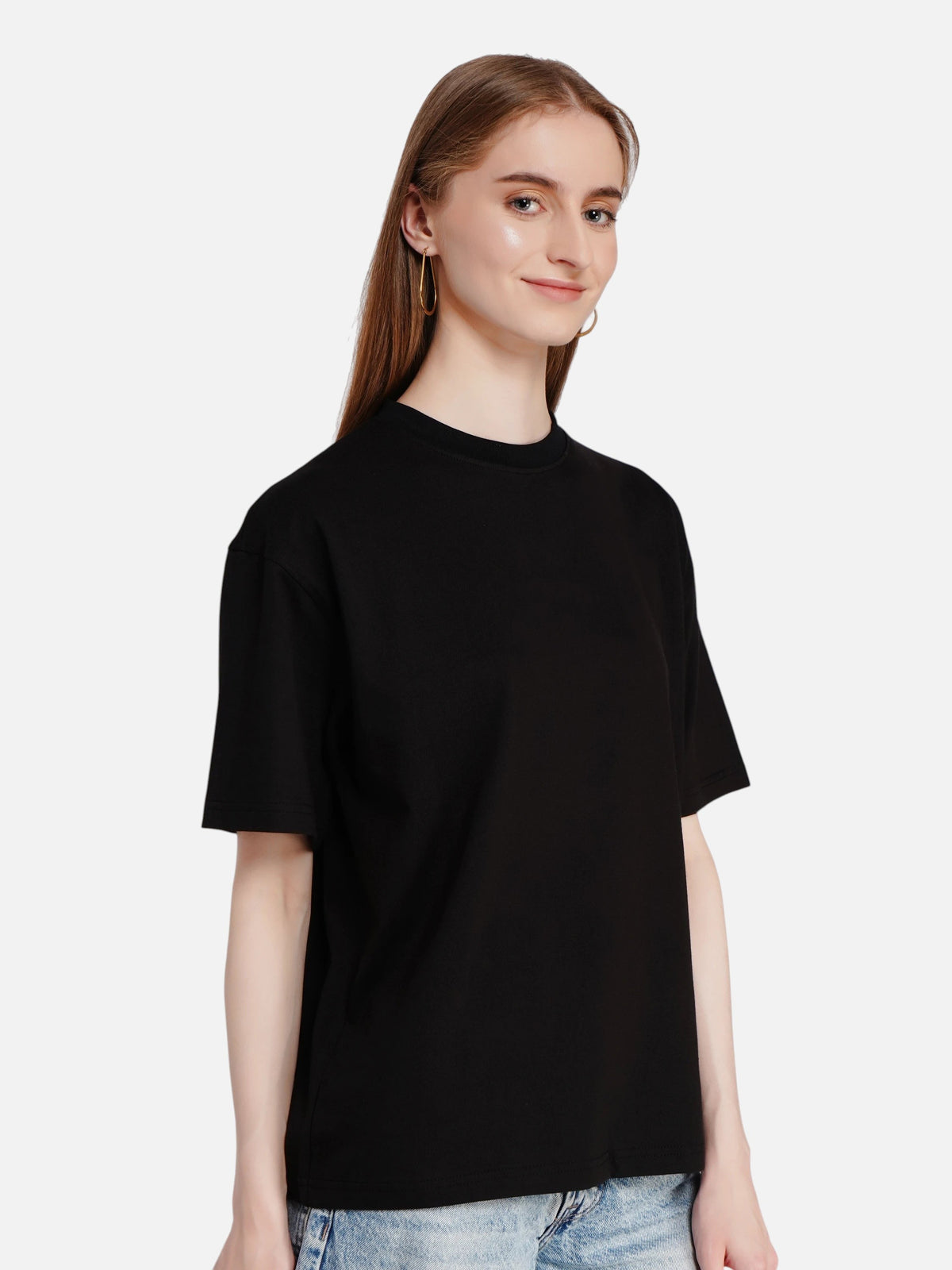 Model wearing an enaay.com black oversized premium cotton t-shirt with a drop-shoulder fit against a plain background.