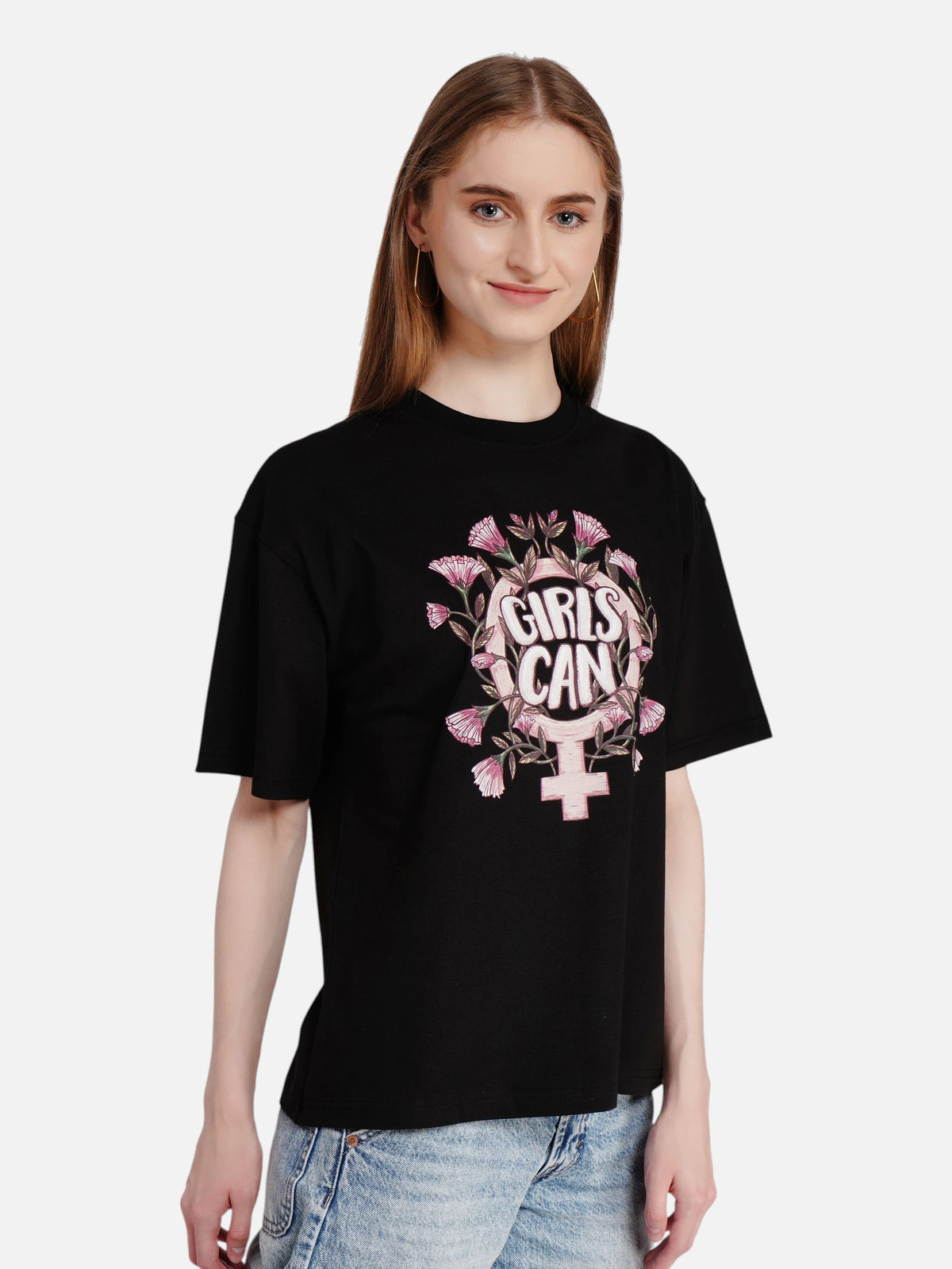 Model wearing an enaay.com black oversized cotton t-shirt with a floral Girls Can graphic print