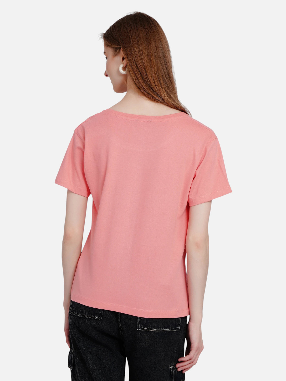 Back view of a woman wearing an enaay.com coral pink cotton round neck t-shirt with short sleeves