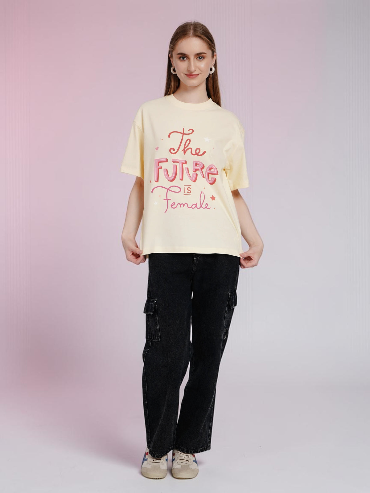 Model wearing an enaay.com light cream oversized cotton t-shirt with pink The Future Is Female graphic print