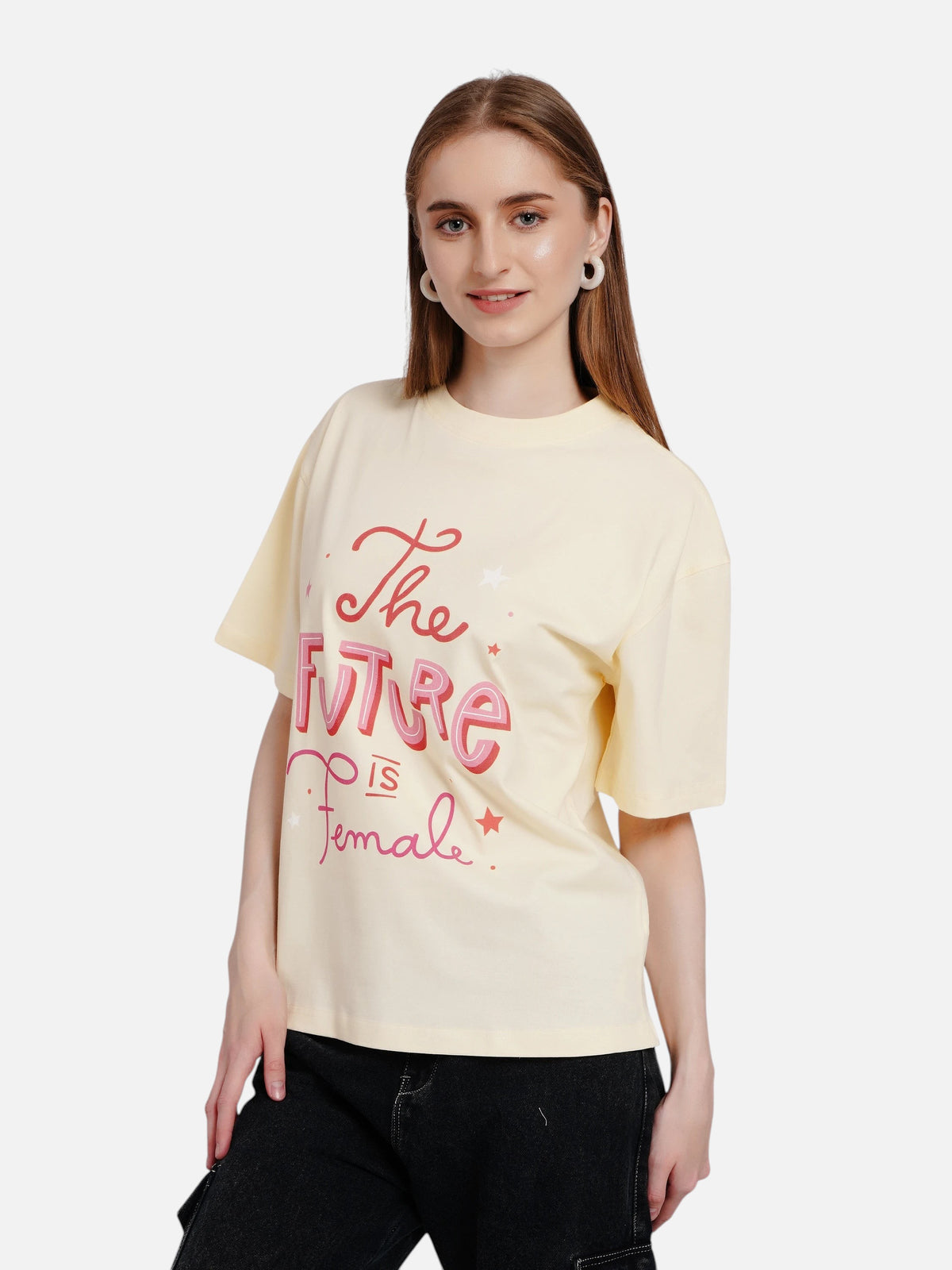 Model wearing an enaay.com light cream oversized cotton t-shirt with pink The Future Is Female graphic print