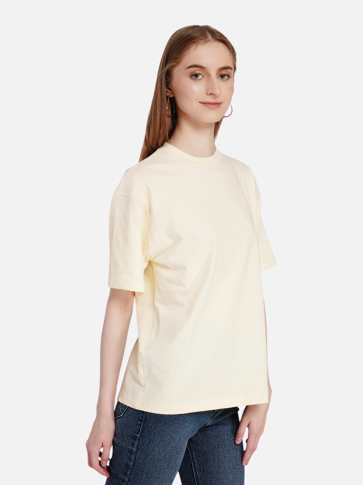 Woman wearing an enaay.com light cream loose fit cotton t-shirt with drop shoulders and a round neck