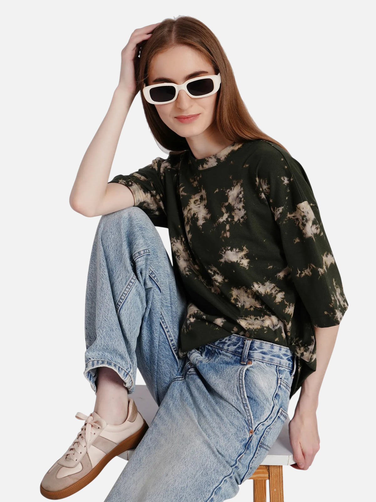 Model wearing an enaay.com dark green acid wash tie-dye oversized cotton t-shirt with light wash jeans and sunglasses