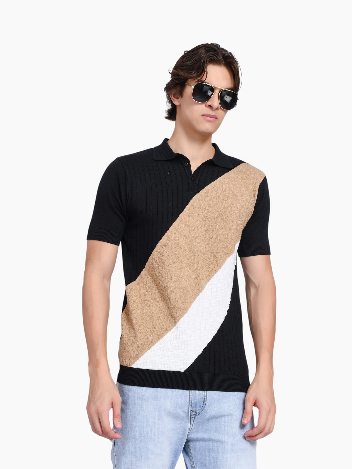 Model wearing enaay.com black, beige, and white diagonal color-block knit polo shirt with sunglasses and light jeans.
