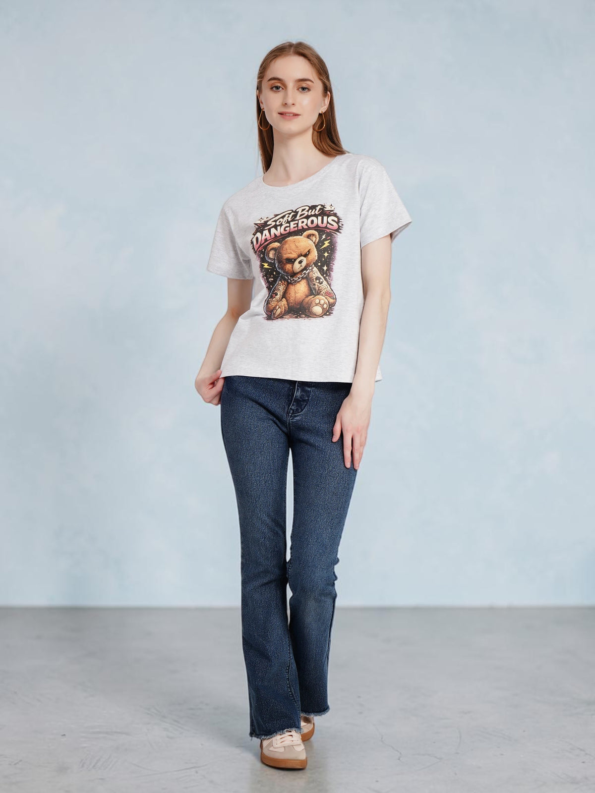 Model wearing an enaay.com grey melange cotton t-shirt with a grumpy tattooed teddy bear graphic print