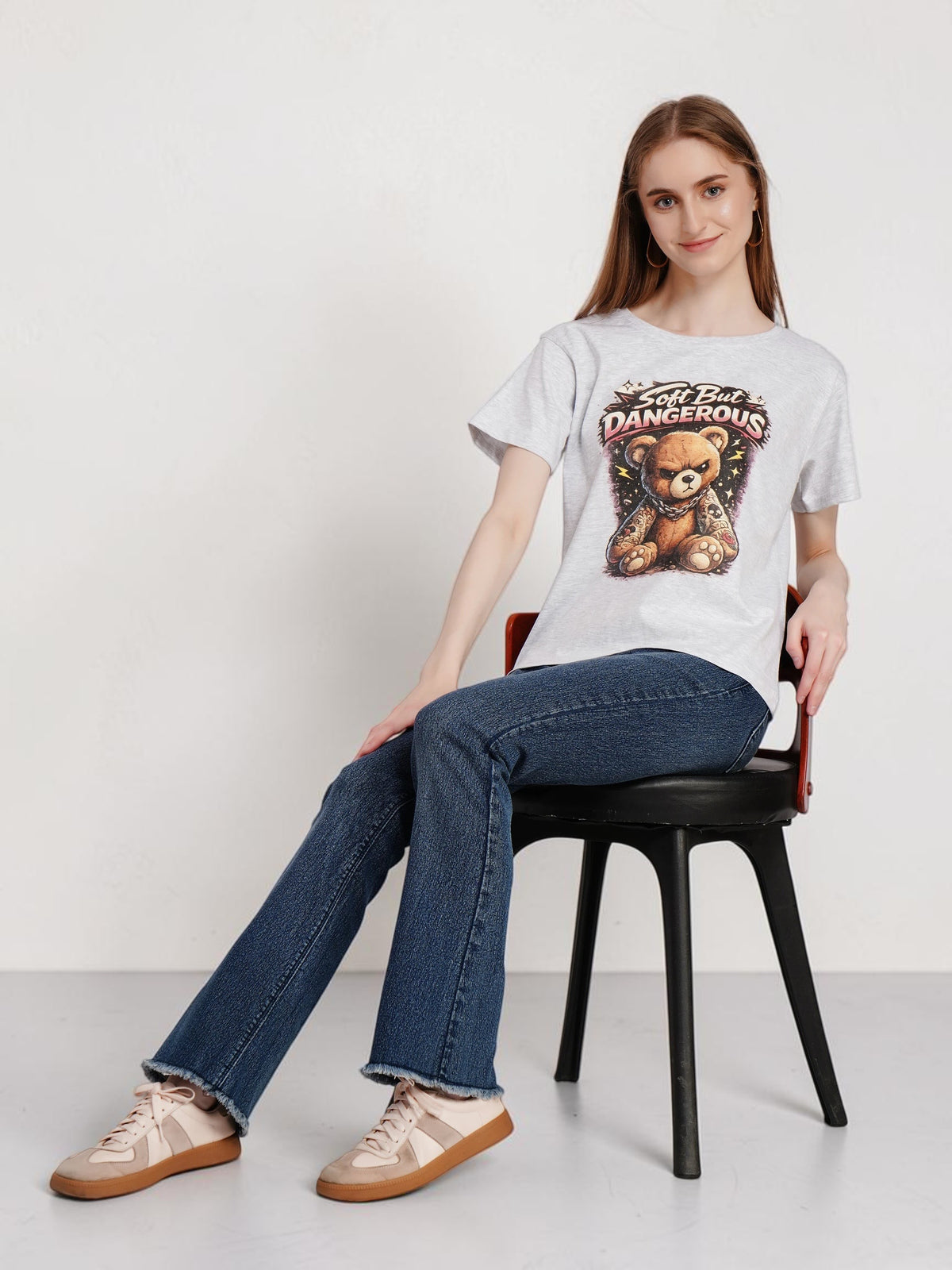 Model wearing an enaay.com grey melange cotton t-shirt with a grumpy tattooed teddy bear graphic print