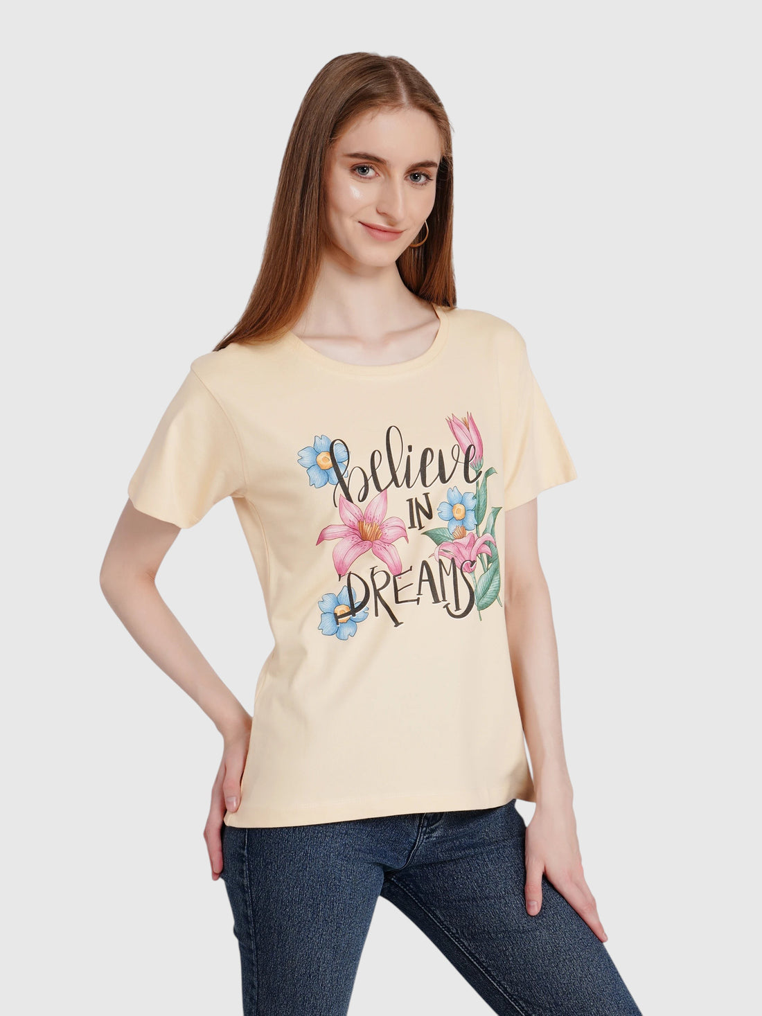 Model wearing an enaay.com light beige cotton t-shirt with a floral Believe In Dreams graphic print