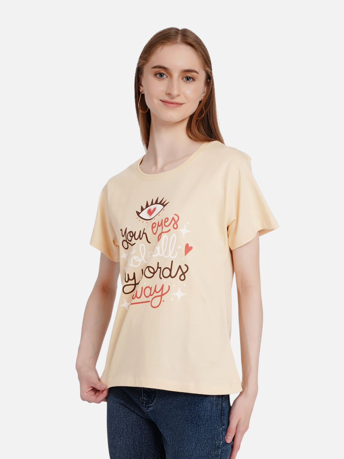 Model wearing an enaay.com light beige cotton t-shirt with a romantic eye and heart graphic print.