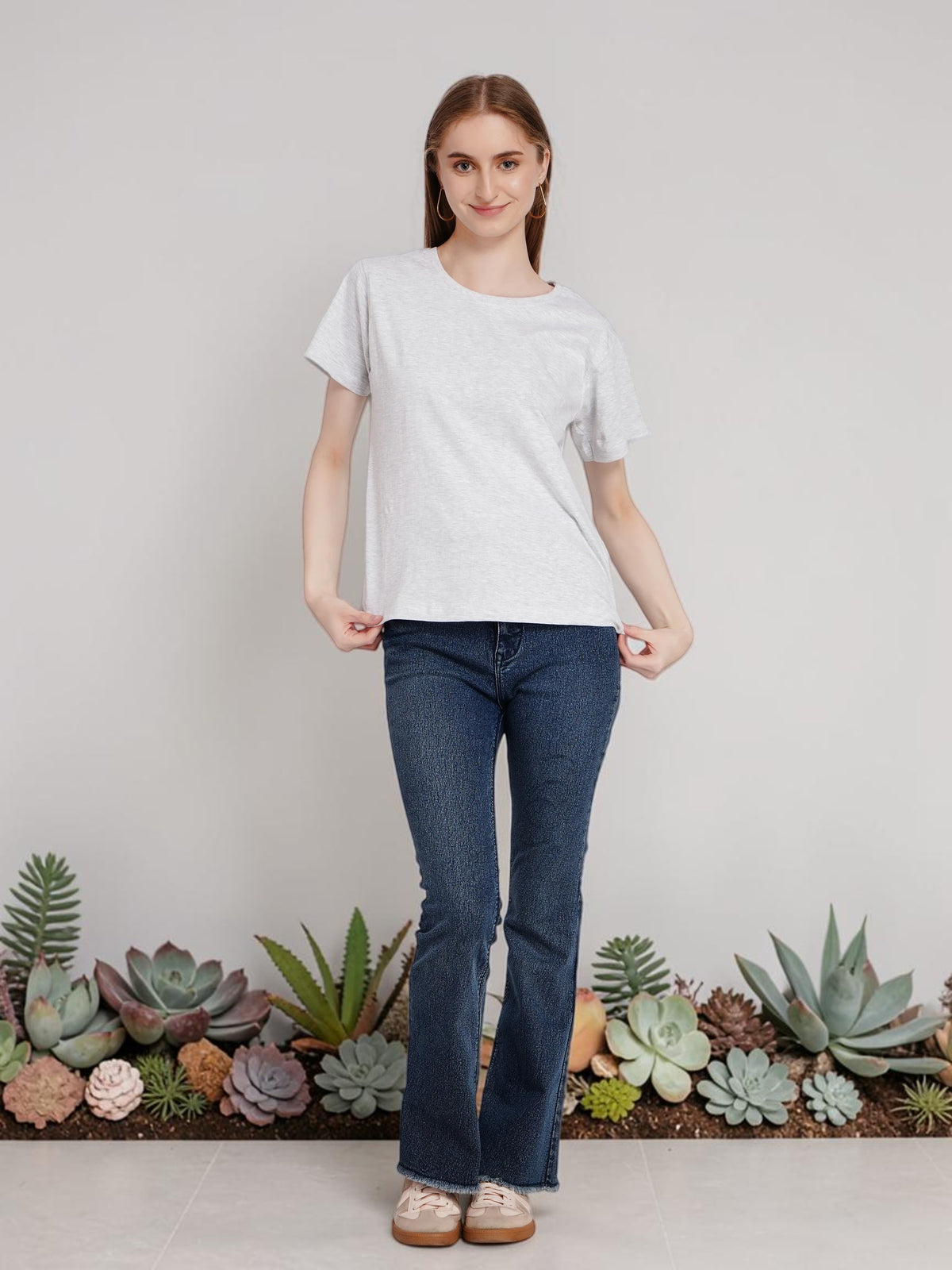 Woman wearing an enaay.com light grey melange cotton round neck t-shirt with short sleeves and regular fit