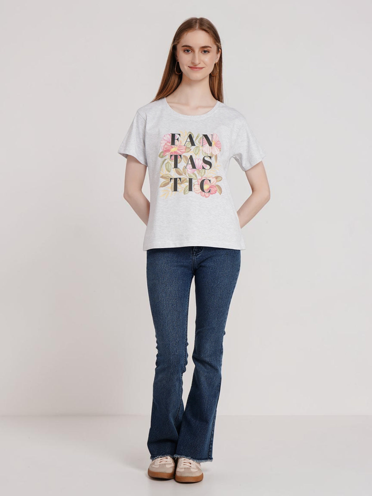 Model wearing an enaay.com light grey melange cotton t-shirt with a floral FANTASTIC graphic print and short sleeves.