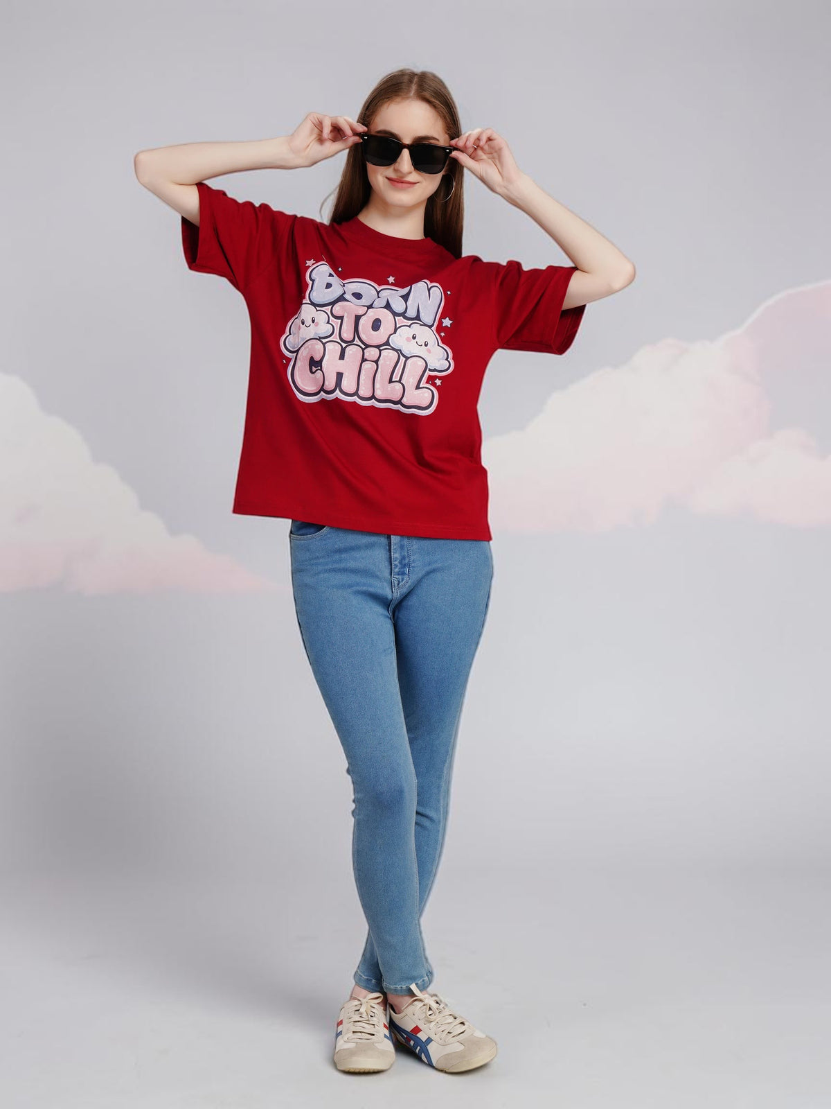 Model wearing an enaay.com maroon oversized cotton t-shirt with Born To Chill bubble letter graphic and sunglasses