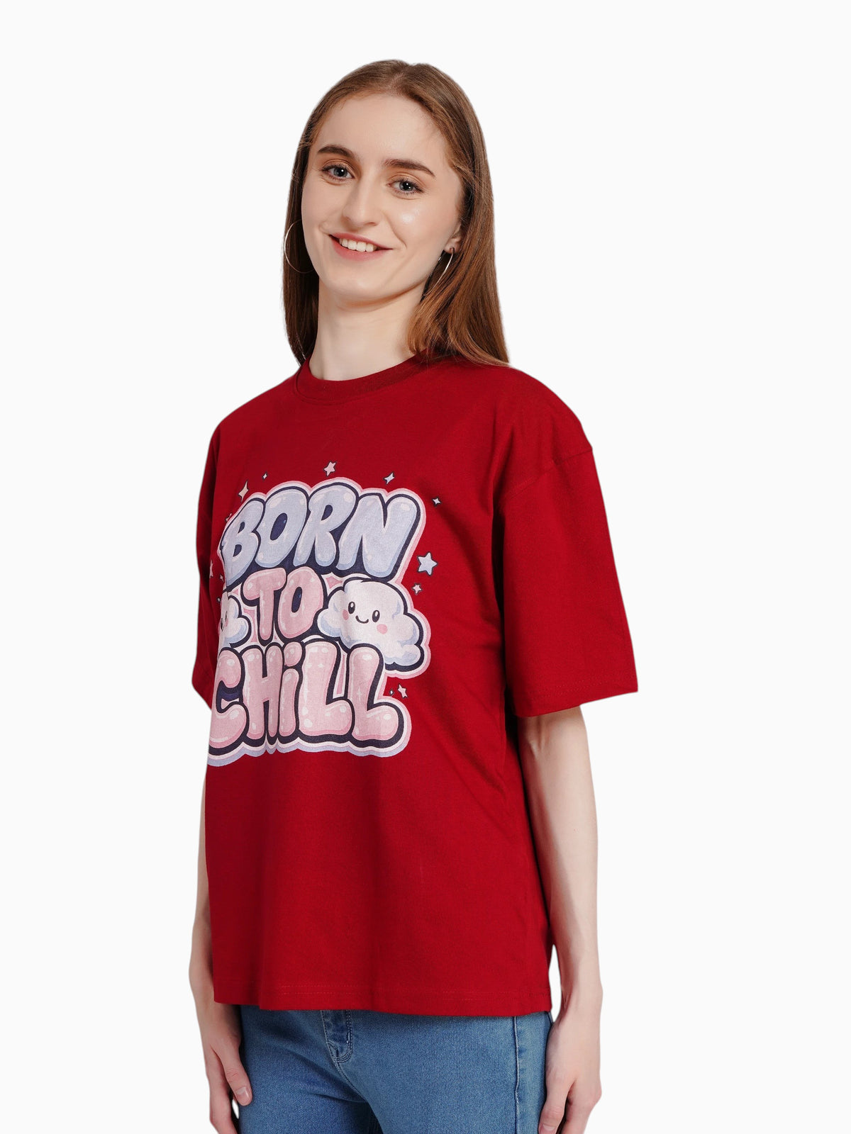 A woman wearing an enaay.com maroon oversized cotton t-shirt with a Born To Chill bubble letter graphic and clouds.