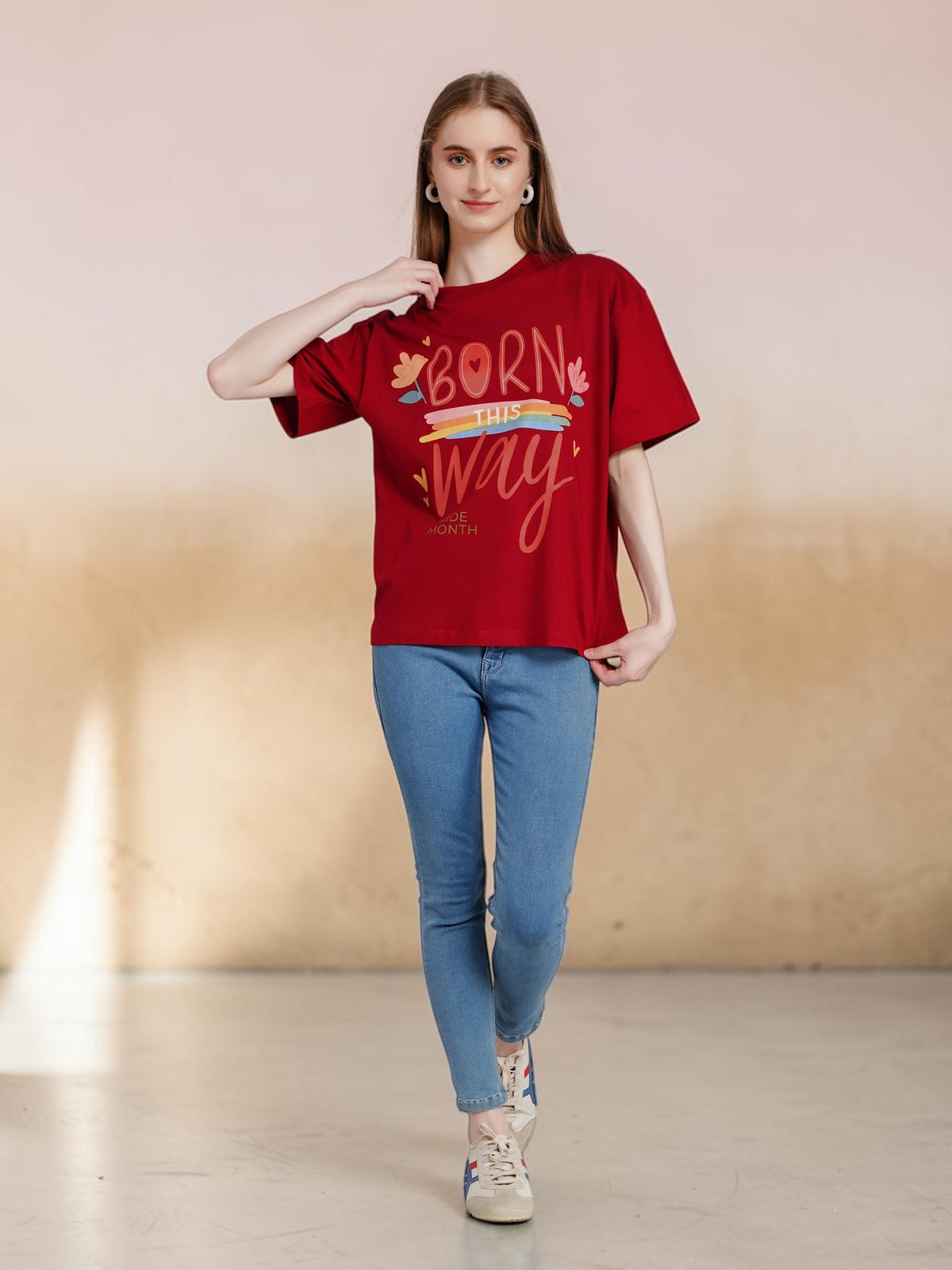 Model wearing an enaay.com maroon oversized cotton t-shirt with Born This Way Pride Month graphic print