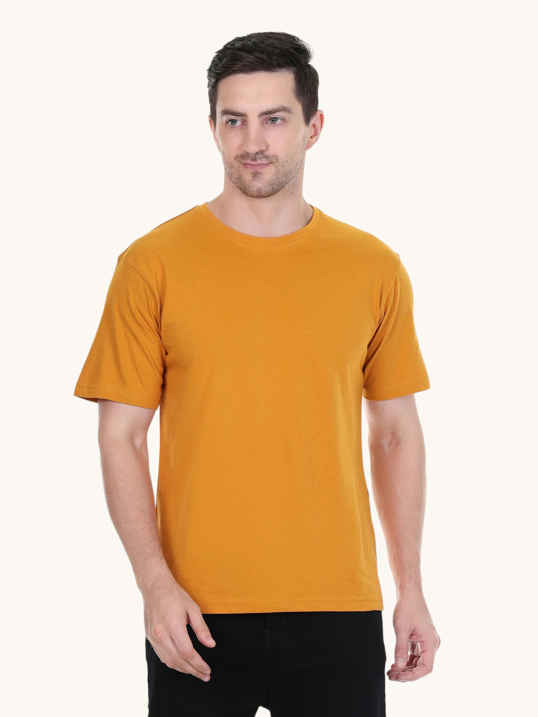 A man wearing an enaay.com mustard yellow round neck t-shirt made from premium cotton in a regular fit.
