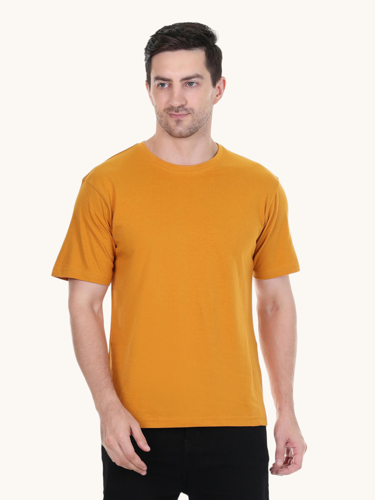 A man wearing an enaay.com mustard yellow round neck t-shirt made from premium cotton in a regular fit.