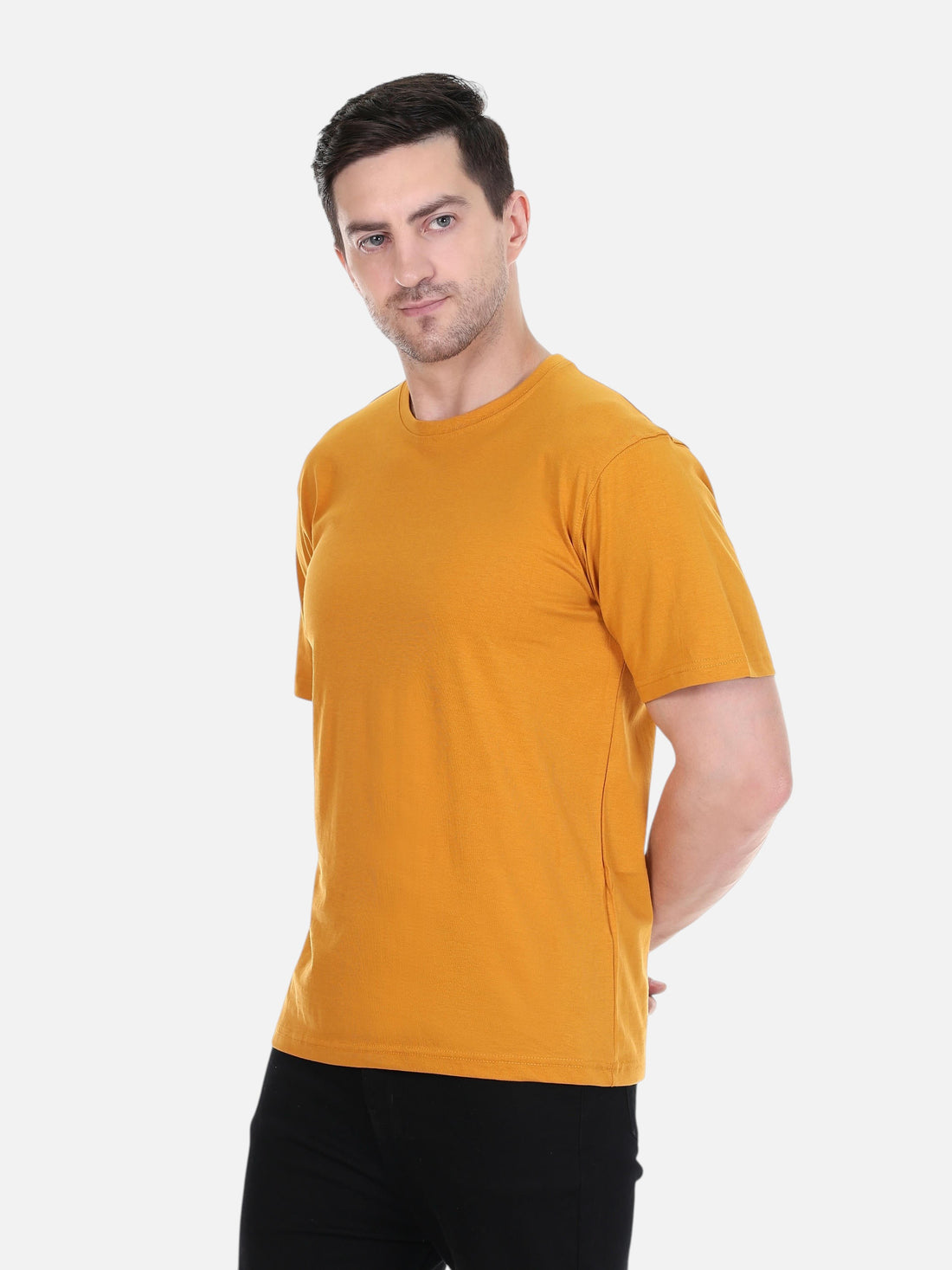 A man wearing an enaay.com mustard yellow round neck t-shirt made from premium cotton in a regular fit.