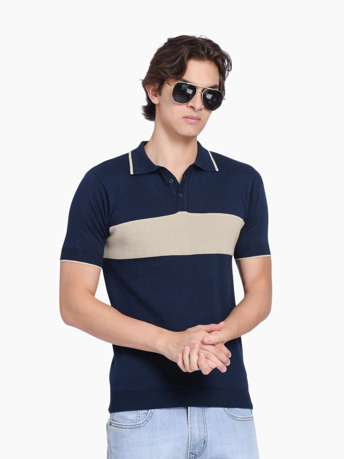Model wearing an enaay.com navy blue cotton knit polo shirt with a beige chest stripe and tipped collar.