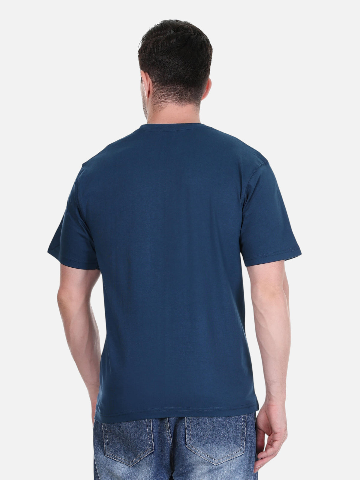 Back view of a man wearing an enaay.com navy blue solid premium cotton round neck t-shirt with jeans