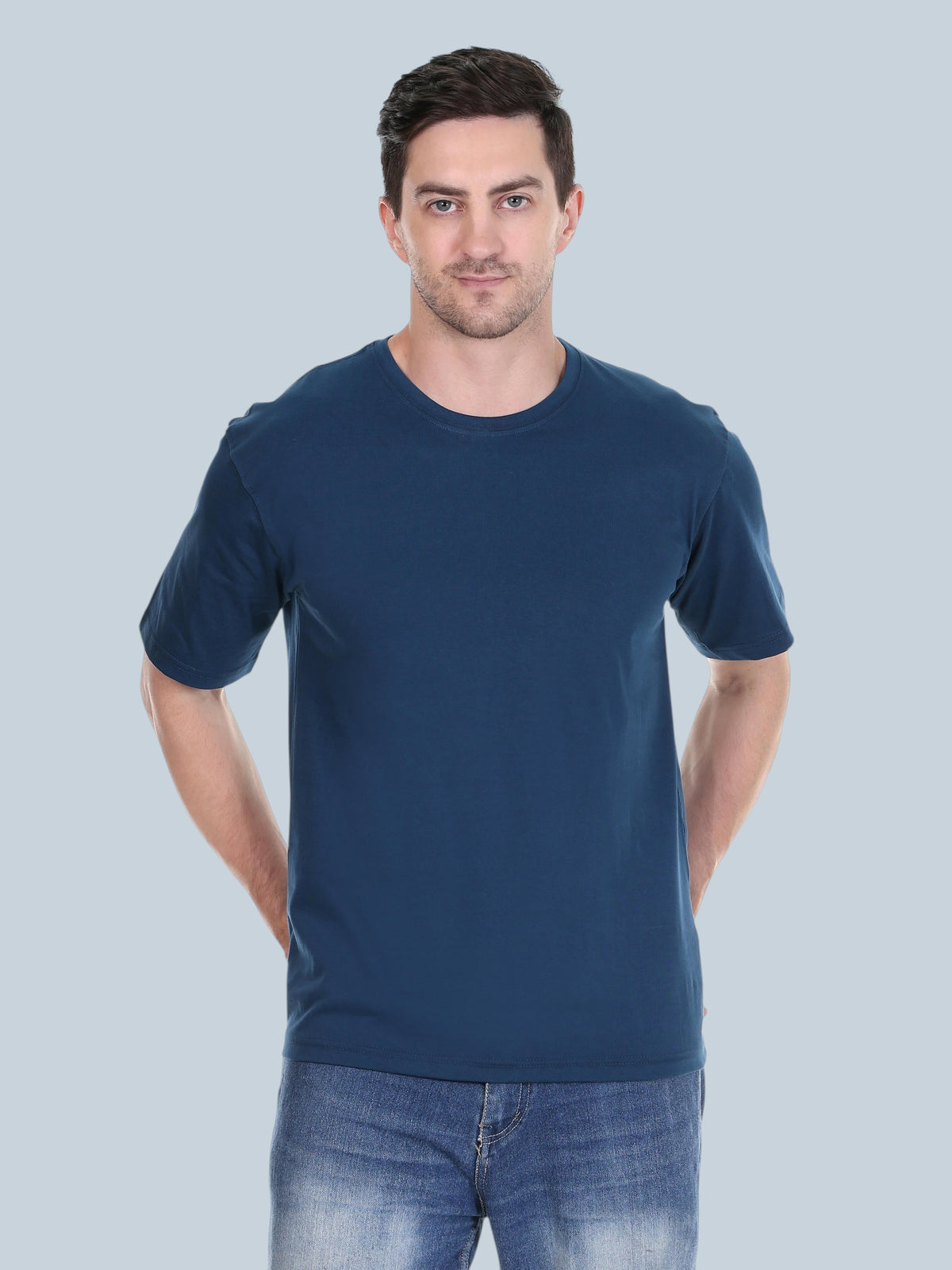 A man wearing an enaay.com navy blue premium cotton round neck t-shirt with a regular fit against a grey background.