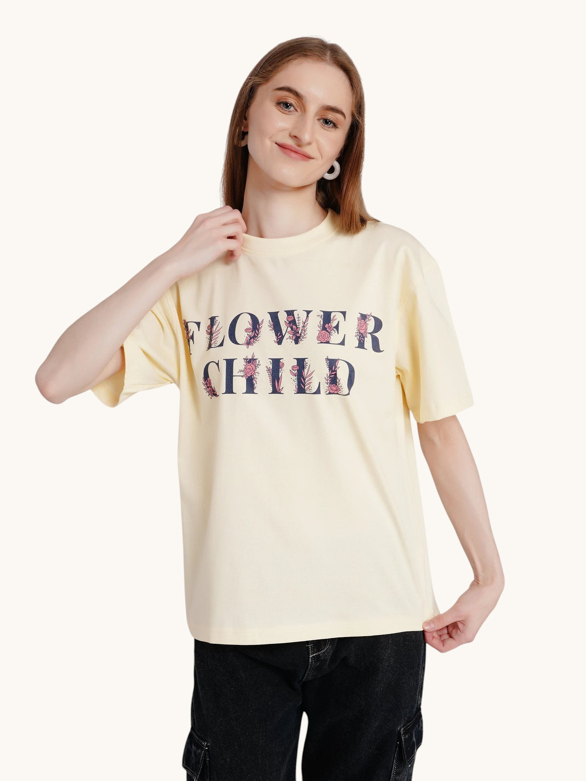 Model wearing an enaay.com off-white oversized cotton t-shirt with a vintage Flower Child graphic print