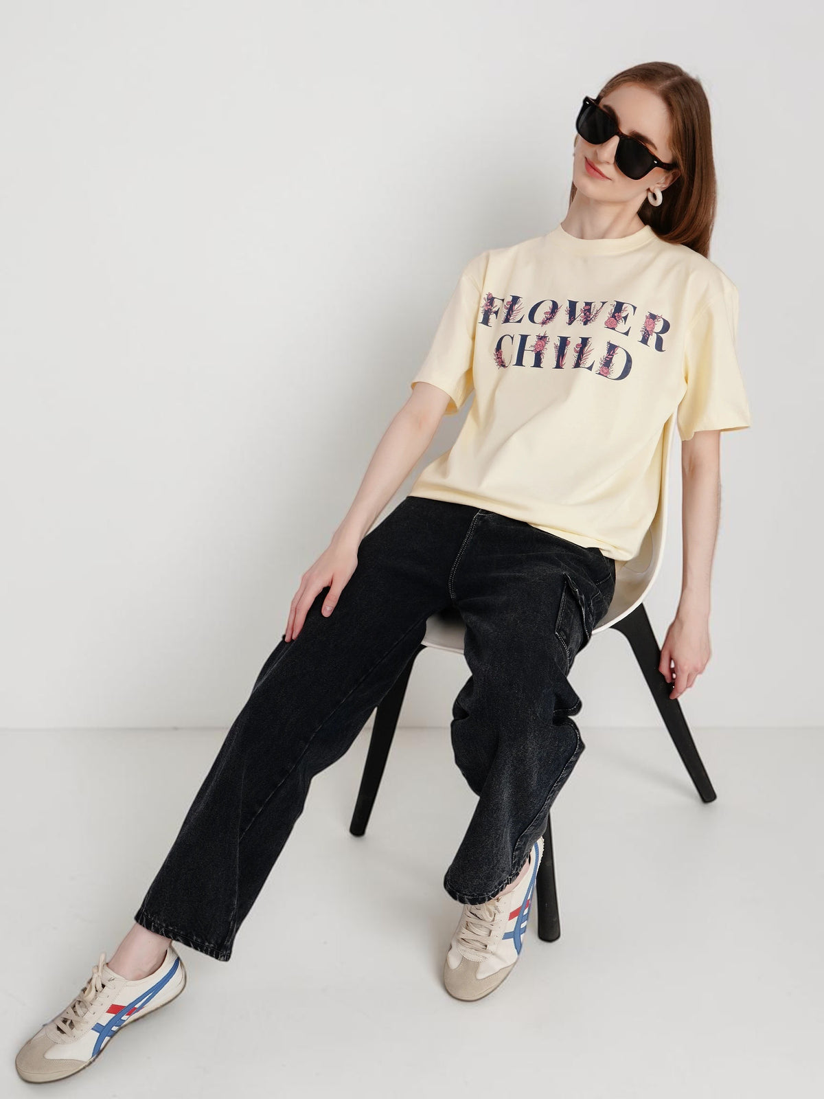 enaay.com off-white oversized cotton t-shirt with Flower Child graphic print worn by a woman in black jeans