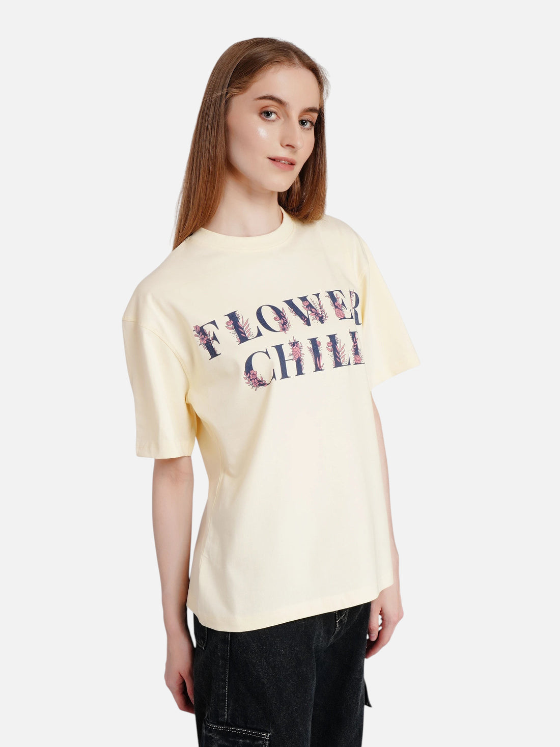 Model wearing an enaay.com off-white oversized cotton t-shirt with a vintage Flower Child graphic print