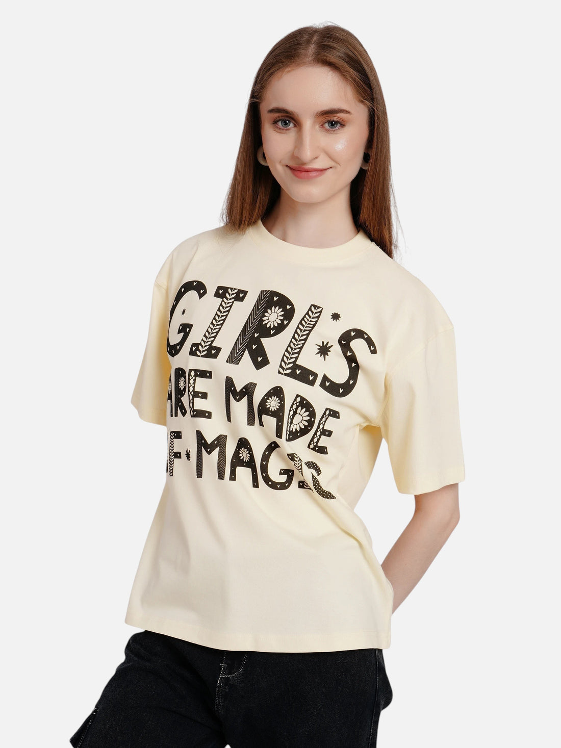 Model wearing an enaay.com off-white oversized cotton t-shirt with a black folk-art graphic print on the front.