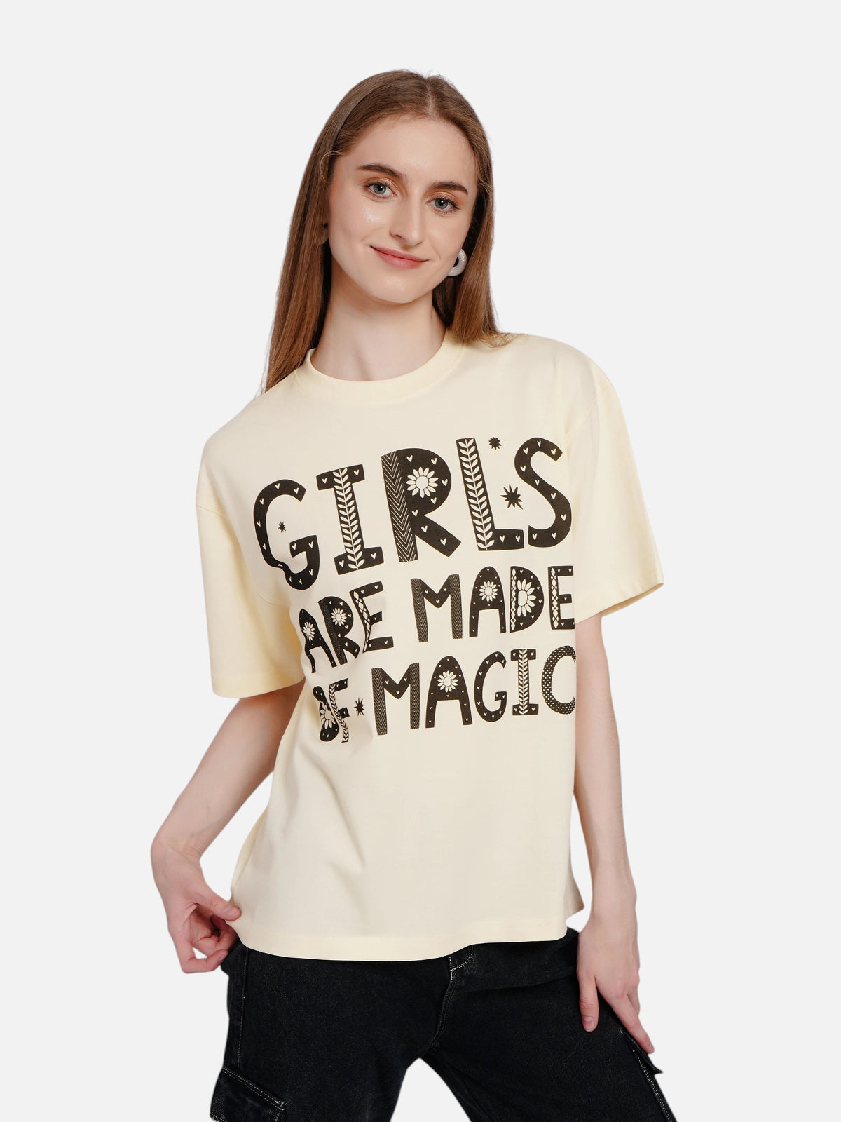 Model wearing an enaay.com off-white oversized cotton t-shirt with Girls Are Made Of Magic folk-art graphic print